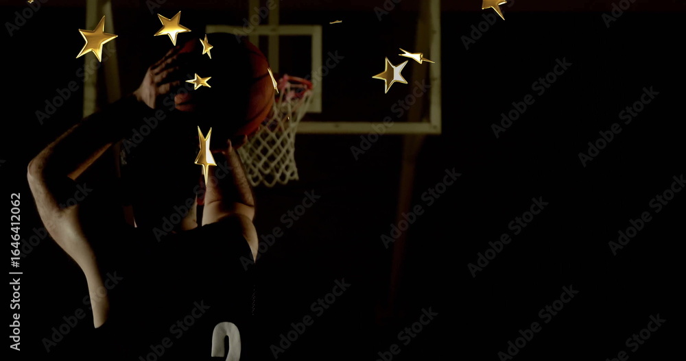 Fototapeta premium Athlete wearing jersey 2 raising basketball overhead in gym, with hoop net, gold stars, copy space