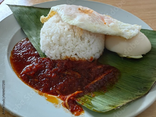 Nasi Lemak Telur Mata:Malaysia's beloved breakfast - creamy coconut rice, unny-yolk egg, crunchy ikan bilis & peanuts, fresh cucumber, and spicy sambal