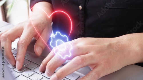 Wallpaper Mural Technology applied to personal care. Close-up of a businesswoman working on her computer with a floating virtual icon of a heart and gear. Torontodigital.ca