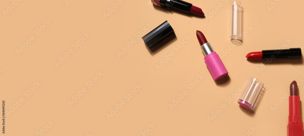 Obraz premium Different lipsticks on beige background with space for text, top view
