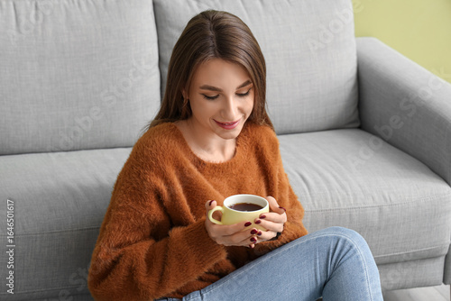 Young woman with cup of tea...