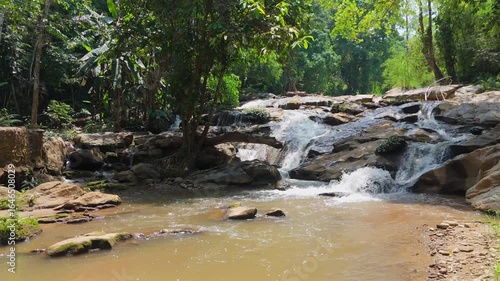 Beautiful waterfall in a tropical forest, Water stream flowing over rocks in a national park, The serene beauty of a jungle creek