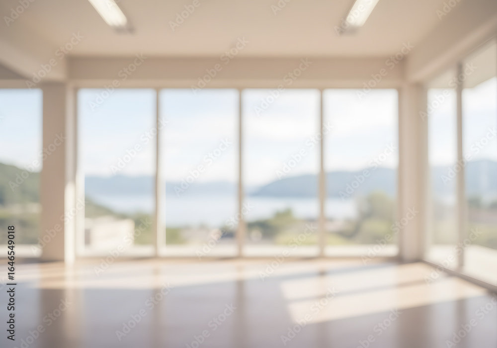 Fototapeta premium Blurred Modern Interior with Large Windows, Natural Light and Scenic Landscape View.