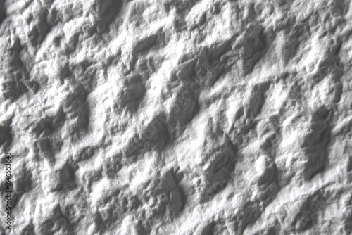 Textured, light gray, surface with ridges and peaks