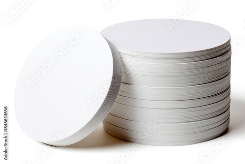 A stack of blank white round coasters