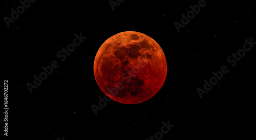 A stunning view of the blood moon during a total lunar eclipse against a backdrop of distant stars in the night sky.