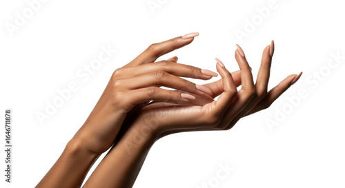 Elegant female hands with nude manicure gently touching each other, isolated on white background, showcasing smooth skin and well groomed nails, expressing grace and beauty