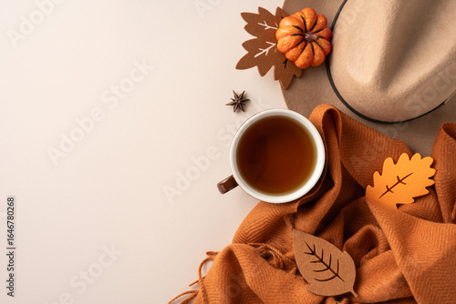 Konstfotografi A cozy composition featuring a cup of tea, autumn leaves, and warm seasonal decor, emphasizing the essence of fall