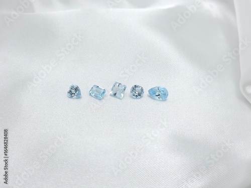 Blue gems on white paper in many shape. Blue topaz loose gems for selling