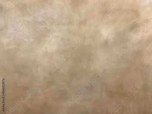 Decorative metallic gold paint on a surface. Random limestone golden washed paint with grunge, and dirt pattern. Seamless background texture.