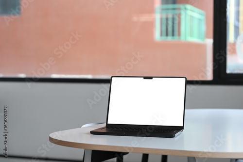 Wallpaper Mural Laptop with blank white screen placed on a white table in a contemporary office Torontodigital.ca