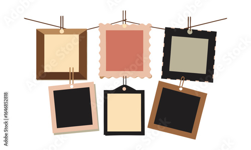 Collection of six vintage and rustic picture frames with blank spaces for photos hanging on a string with clips on a white background