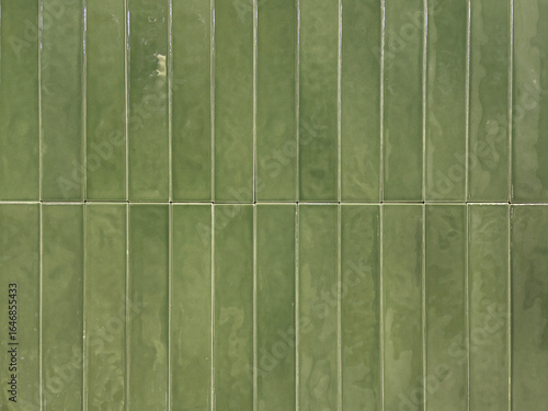 Vertical green subway tiles with white grouts. Seamless tiles background texture.