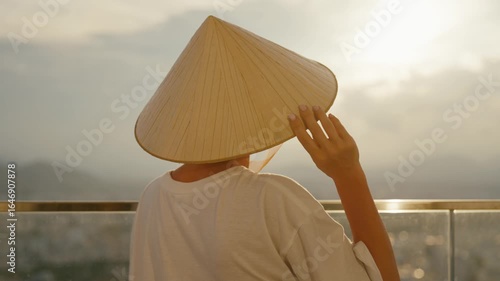 Enjoy the mesmerizing view of a serene sunset coupled with a traditional Asian hat