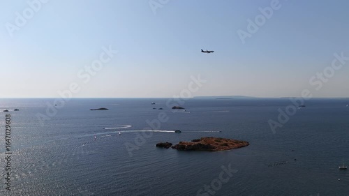 Airplane Approaching Over the Sea with Small Islands and Water Activities. Ibiza