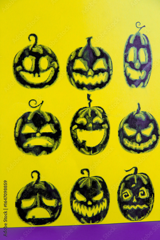 Black pumpkins on a yellow Halloween card