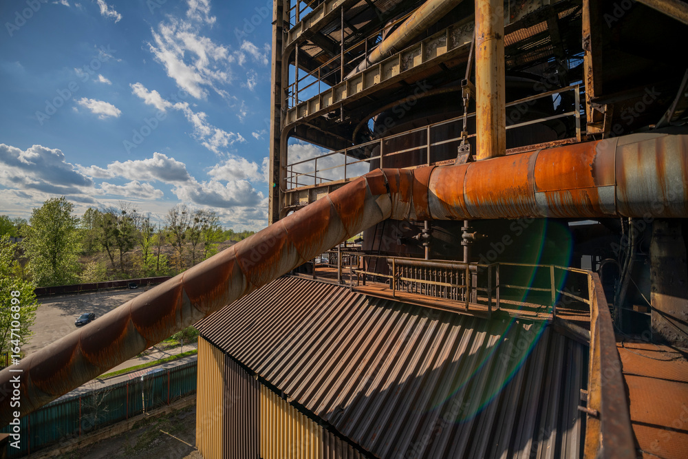 Naklejka premium Abandoned Heavy Industrial Ruins with Large Blast Furnace in Steelworks