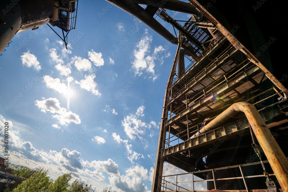 Fototapeta premium Abandoned Heavy Industrial Ruins with Large Blast Furnace in Steelworks