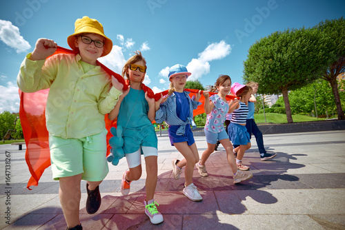 Kids wear capes and enjoy the sunshine outside, embodying childhood adventure and imagination. Concept of creative group play, imaginative summer fun