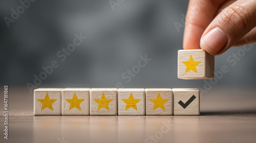 Customer Satisfaction: A hand carefully places the final star on a row of wooden blocks, signifying the complete satisfaction with a five-star rating.