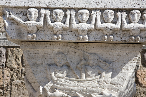 Wall Mural Ancient primitive stone carvings outside the church, Piazza Garibaldi, Montician