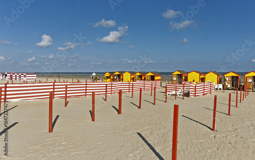 Row of red and yellow beach huts the typical beach equipment of the Belgian coast at De Panne, Belgium.