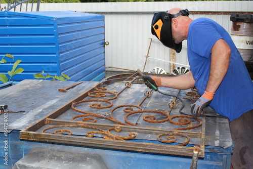 man at home working with metal and welding