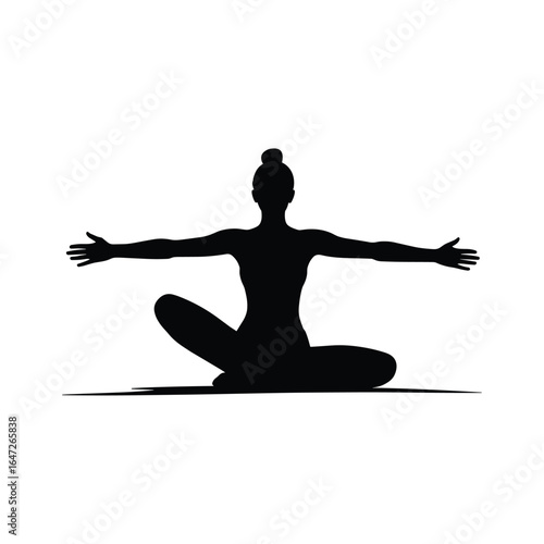 Silhouette of a woman in a yoga pose on a mat