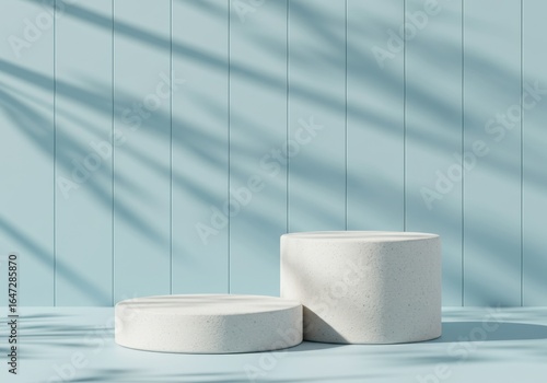 Two concrete cylinders as display podiums on a blue background