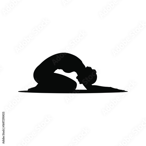 Silhouette of a person in a yoga pose on a mat