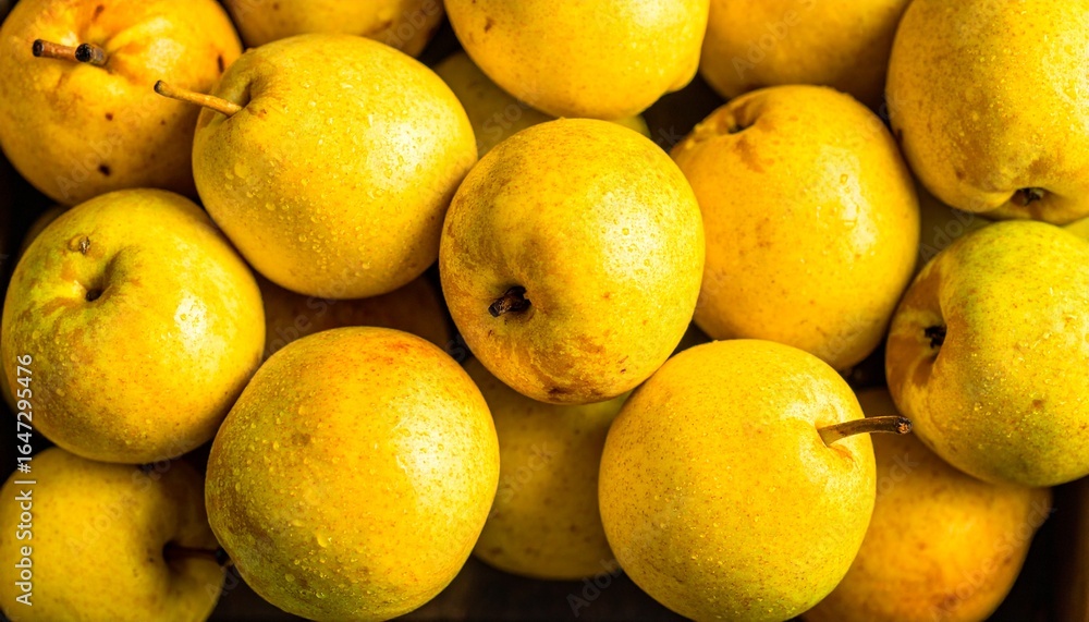 A Close-up View of a Pile of Fresh Yellow Pears, Highlighting their Glossy Texture and the Droplets of Water on the Fruit A Close-up View of a Pile of Fresh Yellow Pears, Highlighting their Glossy Texture and the Droplets of Water on the Fruit
