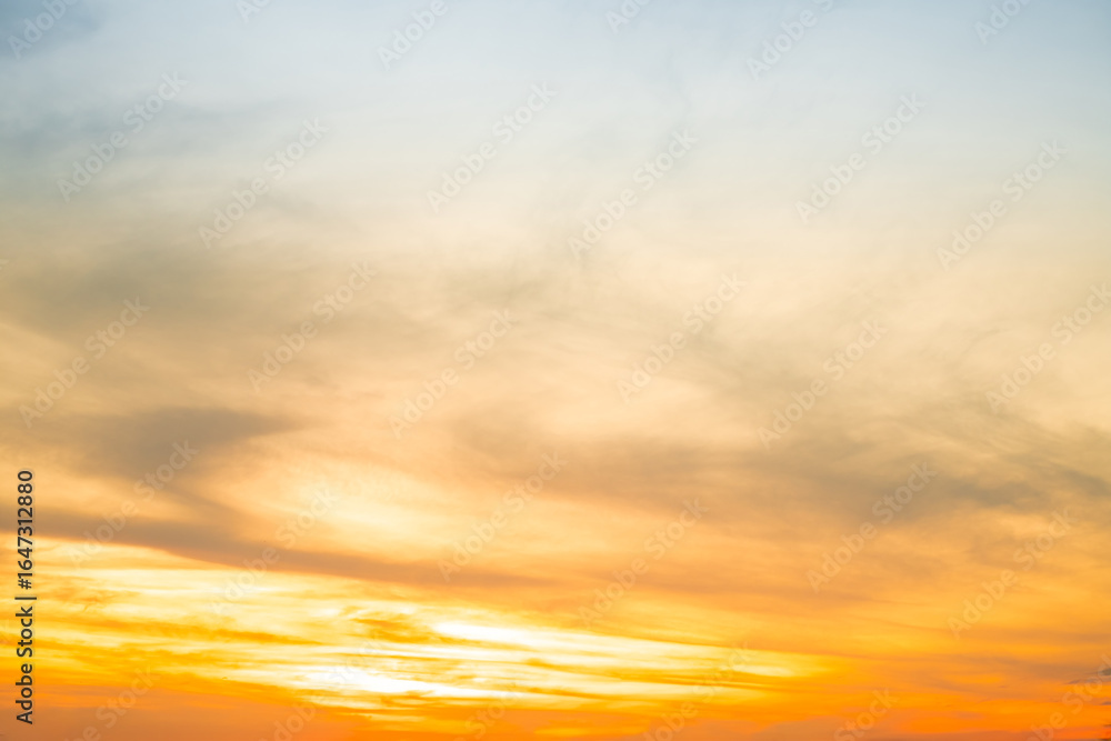 Obraz premium Beautiful , luxury soft gradient orange gold clouds and sunlight on the blue sky perfect for the background, take in evening,Twilight, Large size, high definition landscape photo