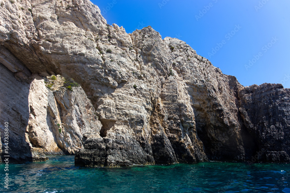 Natural Stone Arch Over Seawater Along the Coastal Cliffs. Zakynthos - Greece Natural Stone Arch Over Seawater Along the Coastal Cliffs. Zakynthos - Greece