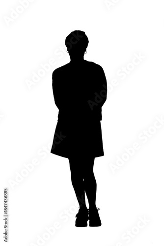 front view full length portrait of a woman in skirt, striped sweater and sneakers with arms on back on white background