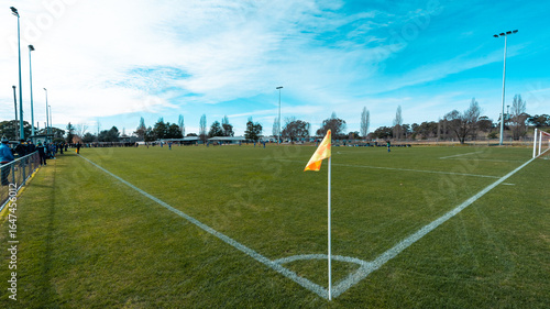 Soccer field corner with yellow flag.