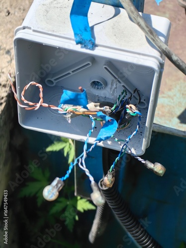 Vászonkép Exposed electrical junction box showing open wires and potential hazards outdoors