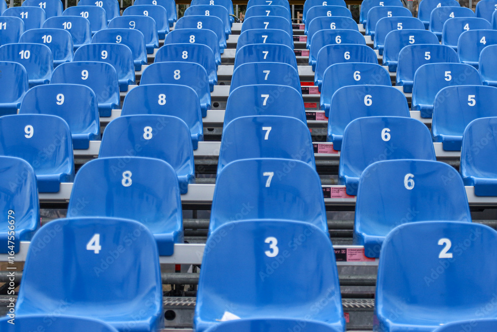 Naklejka premium Identical blue seats at the stadium