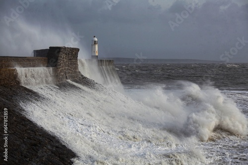 Giant waves hitting the sea wall and lighthouse at Porthcawl.