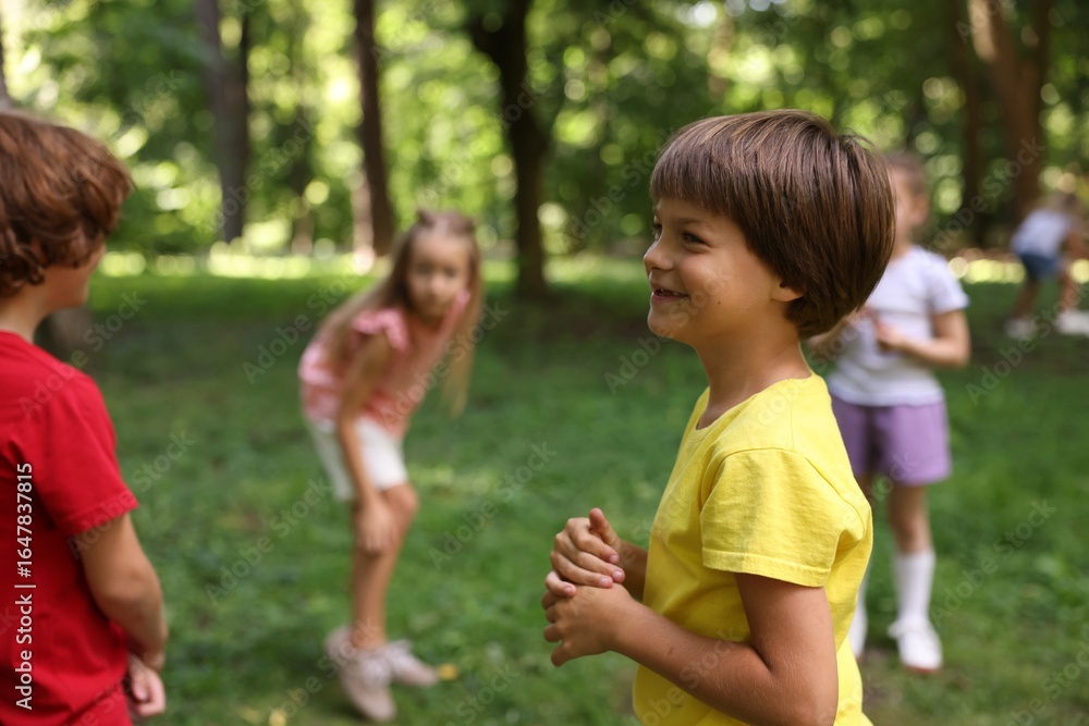 Fototapeta premium Cute little kids having fun together in park, selective focus