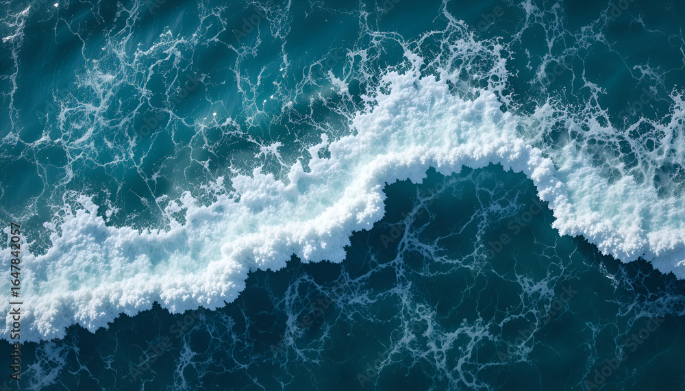 Fototapeta premium Dynamic ocean wave crests with intricate white foam patterns in deep blue water