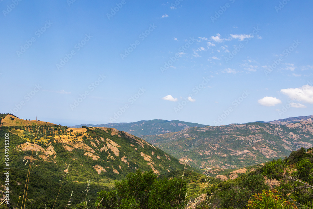 Fototapeta premium Mountain view with green and rocky slopes, Greece, Corfu, 17 June 2025