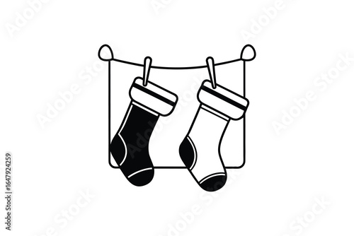 Black and white socks hanging on a clothesline silhouette