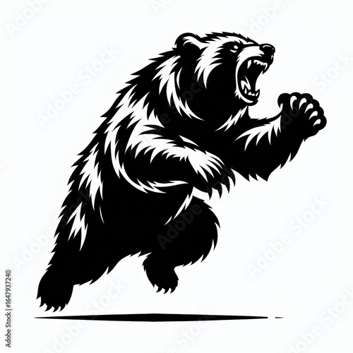 Aggressive grizzly bear charging forward with open mouth and raised paw