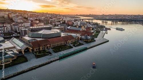 Photography Aerial drone view of Halic Congress Center in Istanbul, modern architecture surrounded by cityscape and waterfront