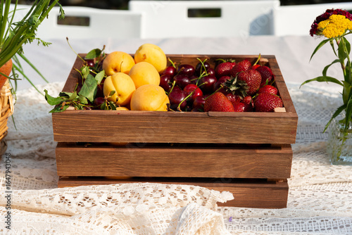 Fresh summer fruits in wooden crate