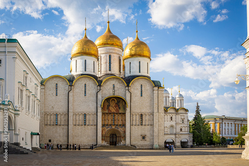Dormition Cathedral with golden domes in the Kremlin, Moscow. Iconic Russian Orthodox church and UNESCO World Heritage site under a bright blue sky