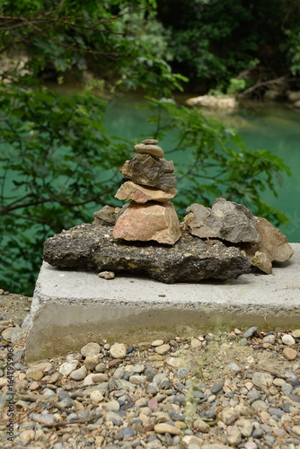 Photo of several rocks piled up with a lake in the background
