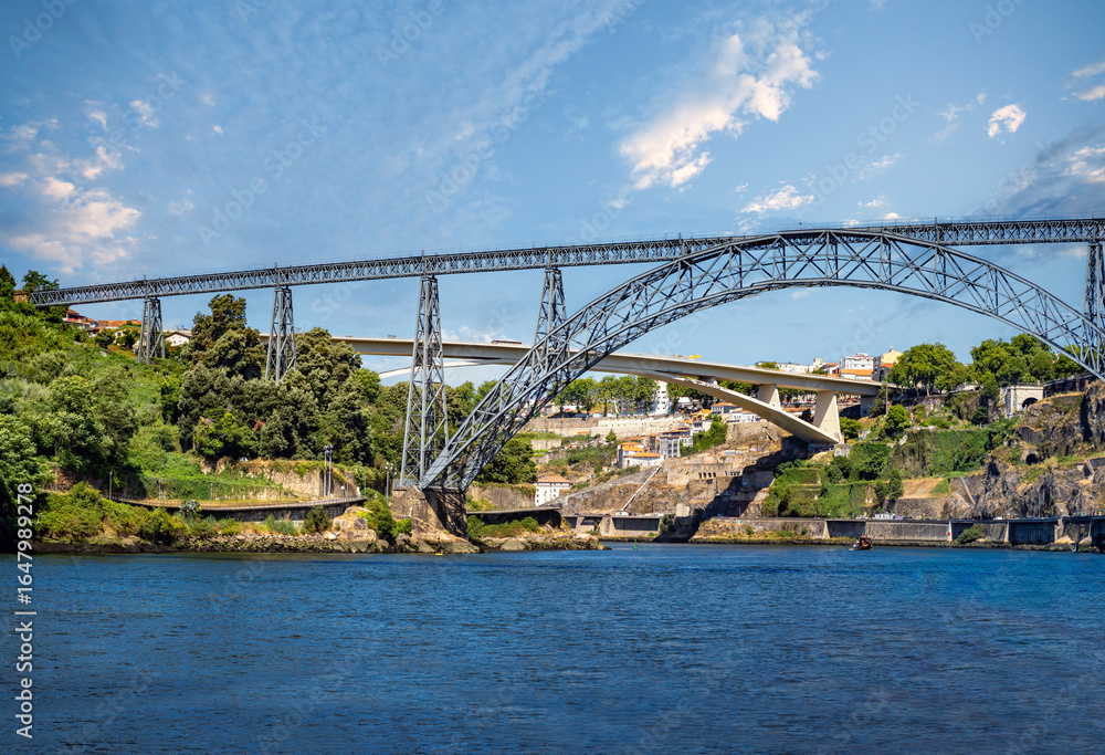 Fototapeta premium City of the briges (Cidade das Pontes), navigating the Douro river under the iconic bridges of the city og Porto (Oporto), Portugal