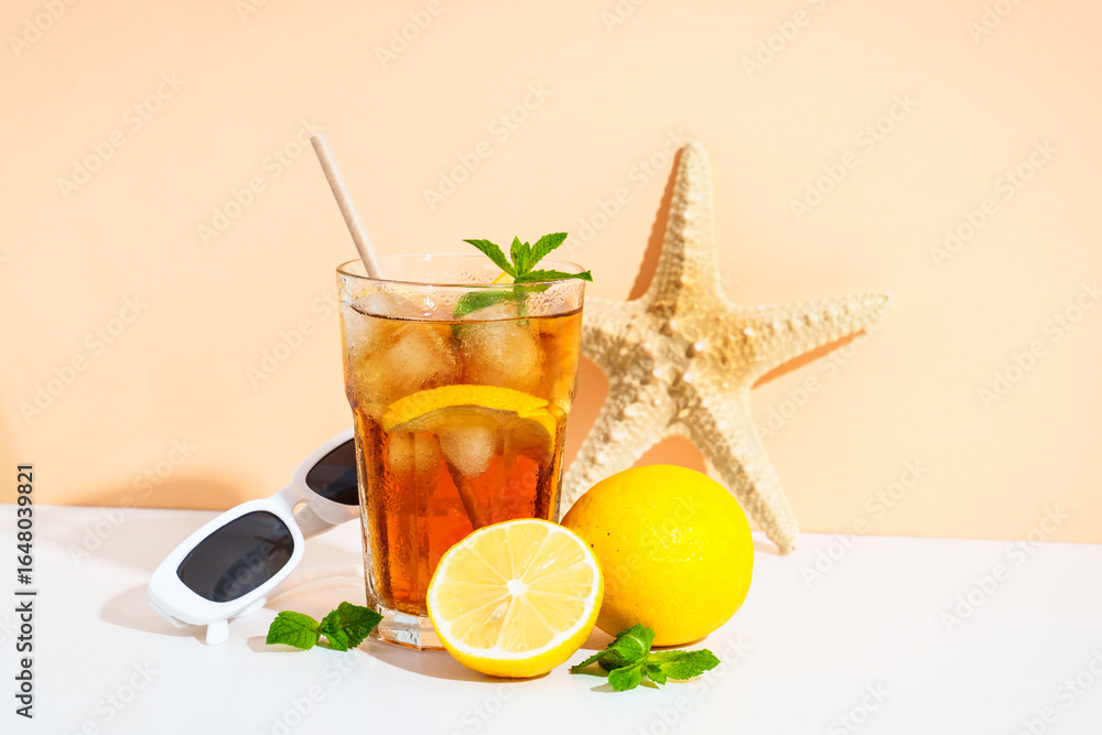 Fototapeta premium Summer iced cocktail drink with sunglasses and sunny shadows.
