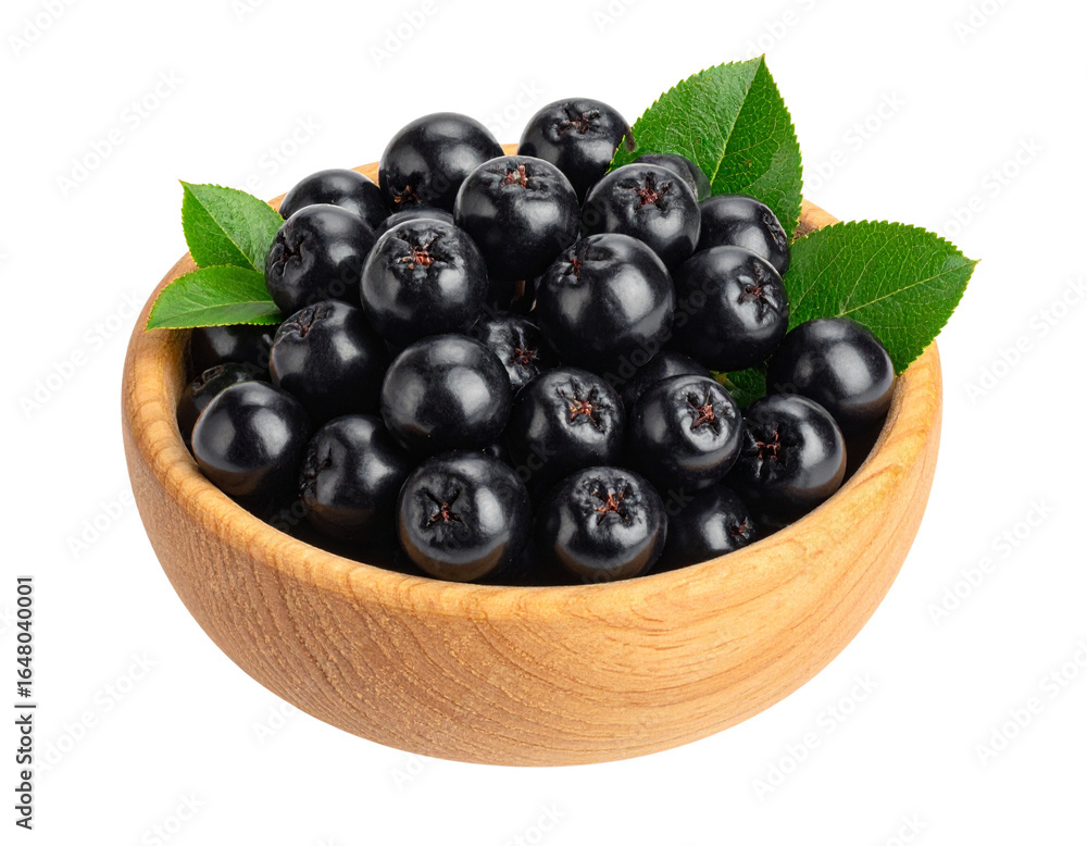 Black chokeberries in wooden bowl isolated on transparent background Black chokeberries in wooden bowl isolated on transparent background